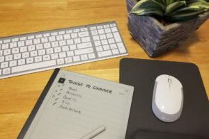 A desktop with a keyboard, mouse, plant and 'Things to Consider' check list.